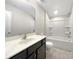 Bright bathroom featuring a vanity with dark cabinets and a shower-tub combo at 1844 Burlington Dr, York, SC 29745