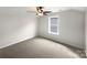 Well-lit bedroom with a ceiling fan and large window with neighborhood views at 1844 Burlington Dr, York, SC 29745