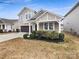 Charming two-story home showcasing a well-maintained yard, covered front porch, and attached garage at 1844 Burlington Dr, York, SC 29745