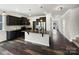 Modern kitchen featuring granite countertops, stainless steel appliances, dark cabinetry, and stylish pendant lighting at 1844 Burlington Dr, York, SC 29745