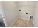 Functional laundry room with built-in shelving and tile flooring at 1844 Burlington Dr, York, SC 29745
