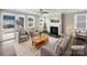 Bright living room with a cozy fireplace, neutral-toned furniture, and natural light from large windows at 1844 Burlington Dr, York, SC 29745