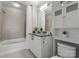 Tiled bathroom featuring a vanity, a cabinet with storage, and a shower-tub combo at 210 N Church St # 1612, Charlotte, NC 28202