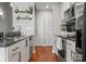 Galley kitchen with stainless appliances, granite counters, and modern shelving at 210 N Church St # 1612, Charlotte, NC 28202