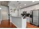 Modern kitchen featuring white cabinets, stainless steel appliances, and dark countertops at 210 N Church St # 1612, Charlotte, NC 28202
