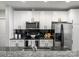 Bright kitchen with white cabinetry, granite countertops, stainless appliances, and black tiled backsplash at 210 N Church St # 1612, Charlotte, NC 28202