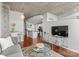 Open floor plan with concrete ceilings, wood floors, gray sofa, and view of the kitchen at 210 N Church St # 1612, Charlotte, NC 28202