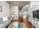 Stylish living room with concrete ceiling, gray sofa, modern lighting, and wood floors at 210 N Church St # 1612, Charlotte, NC 28202