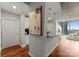 Open concept living room and kitchen with concrete ceilings, modern lighting and hardwood floors at 210 N Church St # 1612, Charlotte, NC 28202