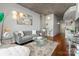 Stylish living room with concrete ceiling, gray sofa, modern lighting, and wood floors at 210 N Church St # 1612, Charlotte, NC 28202