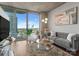 Bright living room with concrete ceilings, wood floors, a large balcony, and city views at 210 N Church St # 1612, Charlotte, NC 28202