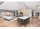 Relaxing lounge with comfortable seating area, modern lighting, TV and communal table at 210 N Church St # 1612, Charlotte, NC 28202