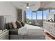 Bedroom features a ceiling fan, hardwood floors, and a walkout balcony with city views at 210 N Church St # 1612, Charlotte, NC 28202