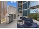 Stylish outdoor lounge with plush seating, a grill, and city views, perfect for relaxation and entertainment at 210 N Church St # 1612, Charlotte, NC 28202