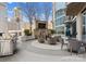 Elegant outdoor lounge area with a stone fireplace, grilling area, and comfortable seating arrangement at 210 N Church St # 1612, Charlotte, NC 28202