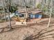 Aerial view of the property featuring a backyard deck, patio, and wooded surroundings at 2400 Whirlaway Ct, Matthews, NC 28105