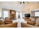 Bright living room with brick fireplace, vaulted ceilings, and French doors to outdoor space at 2400 Whirlaway Ct, Matthews, NC 28105