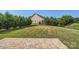 Expansive backyard with a lush lawn, mature trees, and a charming brick patio at 274 Sweet Briar Dr, Fort Mill, SC 29707