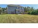 Large backyard with a well-maintained lawn, deck, patio, and grill, ideal for outdoor enjoyment at 274 Sweet Briar Dr, Fort Mill, SC 29707
