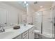 Well-lit bathroom with double sinks, a large mirror, and a glass-enclosed shower, offering a clean and modern aesthetic at 274 Sweet Briar Dr, Fort Mill, SC 29707