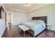 This cozy bedroom features hardwood floors, a ceiling light, and a large window for natural light at 274 Sweet Briar Dr, Fort Mill, SC 29707