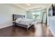 The main bedroom features a tray ceiling, hardwood floors, and a large window for natural light at 274 Sweet Briar Dr, Fort Mill, SC 29707