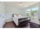 A bedroom with wood floors, a queen-sized bed, and a window for natural light at 274 Sweet Briar Dr, Fort Mill, SC 29707