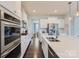 Spacious kitchen features stainless steel appliances, white cabinets, and a large island with countertop seating at 274 Sweet Briar Dr, Fort Mill, SC 29707