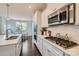 Bright kitchen with white cabinets, stainless steel appliances, and a view into the adjacent breakfast nook at 274 Sweet Briar Dr, Fort Mill, SC 29707