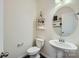 Cozy powder room with stylish shelves, pedestal sink, and neutral decor, maximizing space and functionality at 274 Sweet Briar Dr, Fort Mill, SC 29707