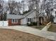 Well-maintained single-story home featuring brick accents, grey siding, and a ramp for easy access at 3008 Overlook Trl, Charlotte, NC 28212