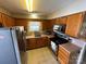 Efficient kitchen featuring stainless steel appliances, wood cabinets, and a window above the sink at 3008 Overlook Trl, Charlotte, NC 28212