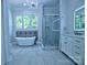 Luxurious bathroom featuring a freestanding tub, a walk-in shower, decorative tile, and a double vanity with modern lighting at 315 Confederate St, Fort Mill, SC 29715