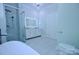 Bright bathroom showcasing a soaking tub, walk-in shower with glass enclosure, double sink vanity, and modern chandelier at 315 Confederate St, Fort Mill, SC 29715