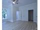 Spacious bedroom with neutral walls, ceiling fan, wood-look flooring, and natural light from a double hung window at 315 Confederate St, Fort Mill, SC 29715
