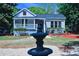 Charming home featuring a lovely front porch, tidy landscaping, and a decorative fountain at 315 Confederate St, Fort Mill, SC 29715