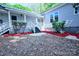 Charming home exterior with covered porch, red mulch landscaping, and mature trees at 315 Confederate St, Fort Mill, SC 29715