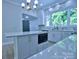 Bright kitchen with an island that has seating and undercounter storage; features a white countertop and white cabinets at 315 Confederate St, Fort Mill, SC 29715