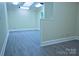 An open room showcasing gray vinyl floors and neutral walls, bathed in light from the skylight at 315 Confederate St, Fort Mill, SC 29715