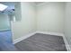 Spacious room showcasing gray vinyl flooring, neutral walls, and modern trim, ready for personal touches at 315 Confederate St, Fort Mill, SC 29715