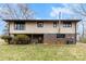 The rear exterior view of the home revealing a brick foundation and walkout basement at 32 Bowen Dr, Belmont, NC 28012