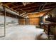 Spacious unfinished basement with visible ceiling beams and a garage door at 32 Bowen Dr, Belmont, NC 28012