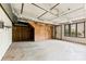 Unfinished basement space with cement floor, a few walls and doors, and industrial lighting at 32 Bowen Dr, Belmont, NC 28012