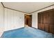 Bedroom with a closet, a door and blue carpet flooring throughout at 32 Bowen Dr, Belmont, NC 28012