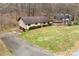 Charming single-Gathering home with an attached garage and spacious front lawn, nestled among mature trees at 32 Bowen Dr, Belmont, NC 28012