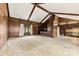 Spacious living room with wood paneling, vaulted ceiling, and seamless flow into the kitchen at 32 Bowen Dr, Belmont, NC 28012