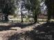 Fenced-in backyard with scattered leaves and several trees providing ample shade at 322 E Houston St, Monroe, NC 28112