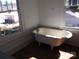 Bathroom featuring a clawfoot tub with hardwood floors and window at 322 E Houston St, Monroe, NC 28112