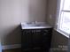 Bathroom vanity with dark wood cabinets, drawers, quartz countertop and window views at 322 E Houston St, Monroe, NC 28112