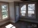 Bedroom featuring windows for natural light and hardwood floors at 322 E Houston St, Monroe, NC 28112